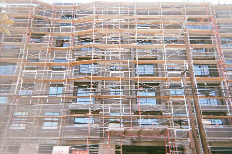 wood scaffolding forming a pattern against a building